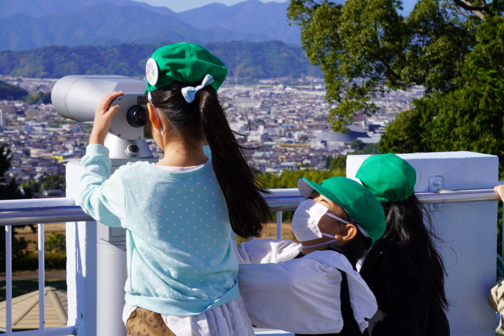 望遠鏡で静岡の景色を見る子供達