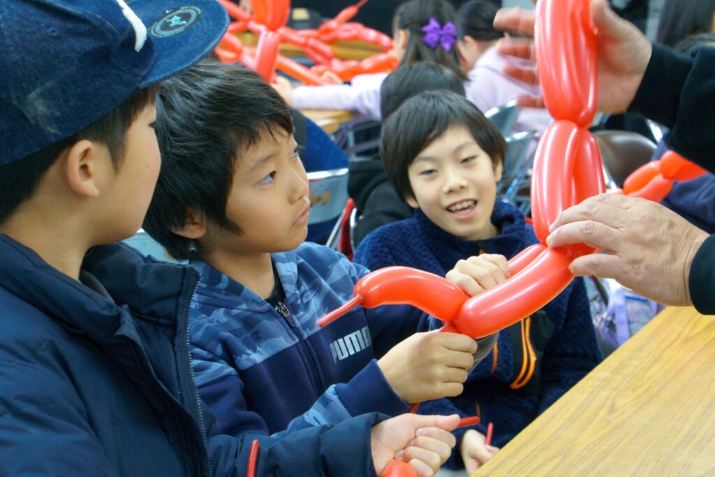 バルーンをねじってもらっている子どもたち