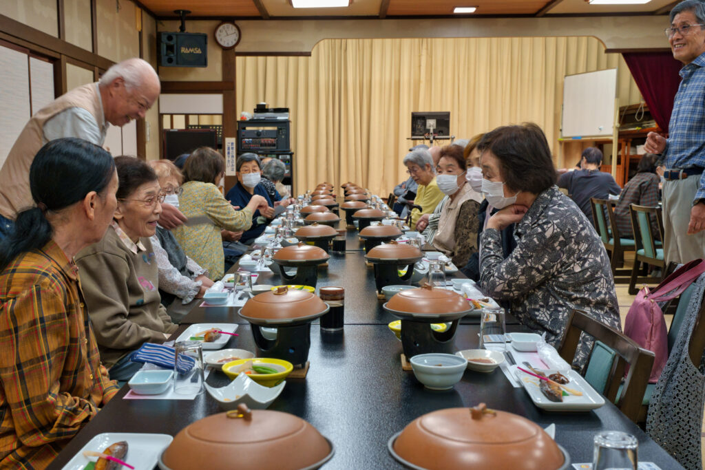 並んでいる料理を楽しそうにみる会員たち